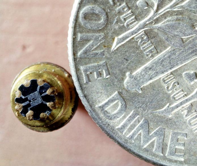 Fairchild's first IC, the “F” element flip-flop compared to a dime coin. Photo: Getty Images